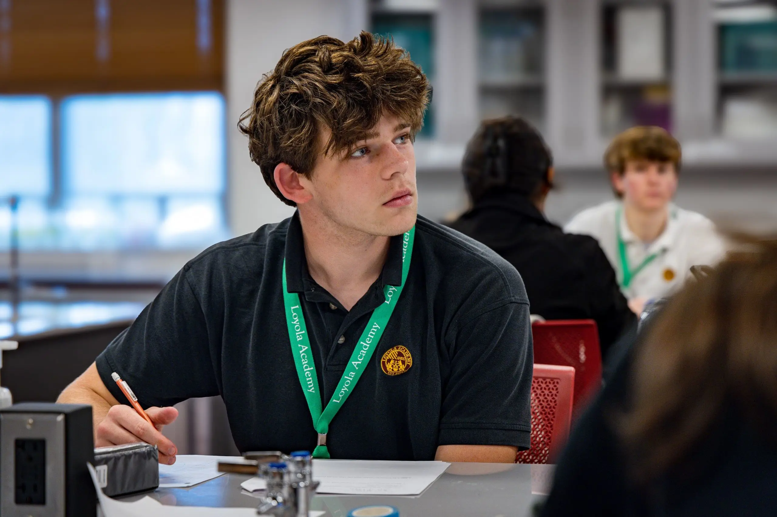 Loyola Academy student studying attentively in a classroom during the school day.