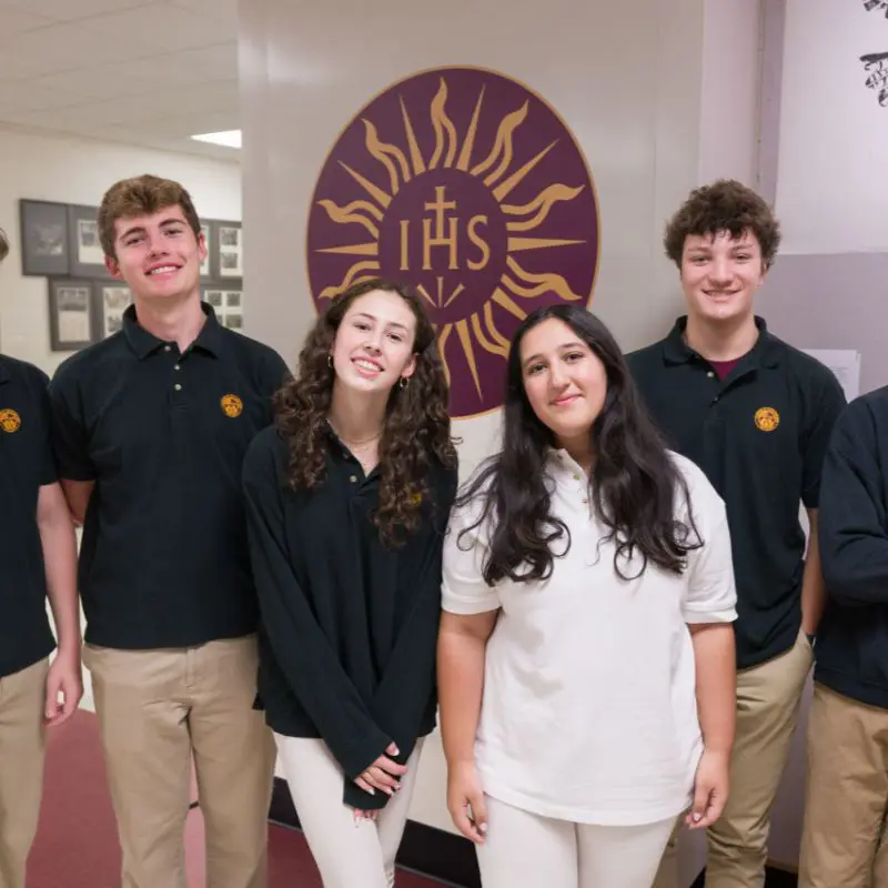 A diverse group of Loyola Academy students smiling together, representing the inclusive community supported by tuition assistance and financial aid.