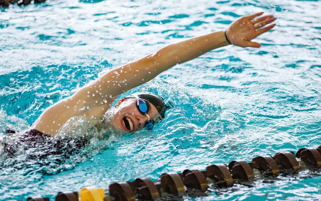 Loyola Academy student swimmer training in the Norcross Aquatic Center pool, demonstrating focus, strength, and Ignatian perseverance.